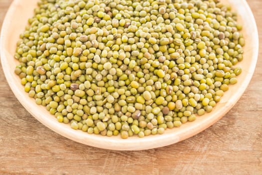 Raw green bean in wooden plate, stock photo