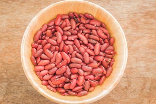 Raw red kidney bean in wooden bowl, stock photo