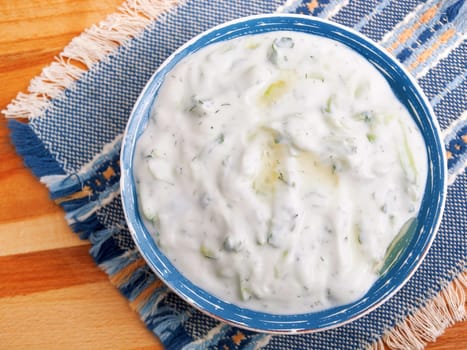 Tzatziki is appetizer from the Greek cuisine made of strained yogurt with cucumbers, garlic and fresh green herbs