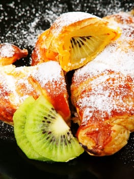 Croissants with kiwi fruit and caster sugar