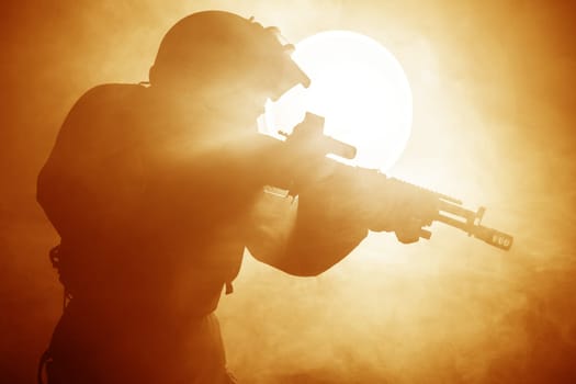 Russian special forces operator in bulletproof helmet in the smoke and fire