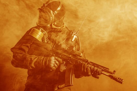 Russian special forces operator in bulletproof helmet in the smoke and fire