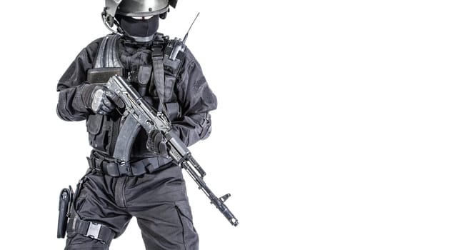 Russian special forces operator in black uniform and bulletproof helmet