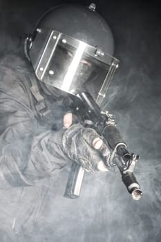 Russian special forces operator in black uniform and bulletproof helmet