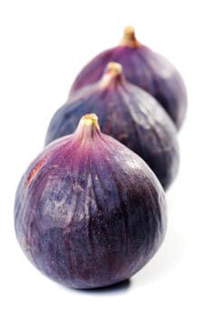 Figs arranged in a row isolated on white