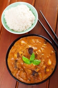 Vegetarian thai curry with eggplant and patatoes served with steamed rice