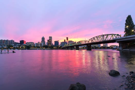 Pink Sunset over Portland Oregon downtown waterfront city skyline along Willamette River by Hawthorne Bridge