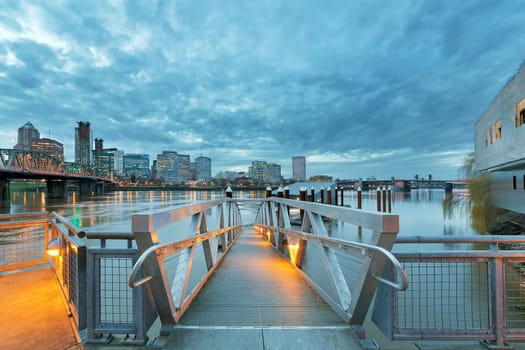 Portland Oregon downtown city skyline by the Pier and Hawthorne Bridge along Willamette River at Twilight Evening