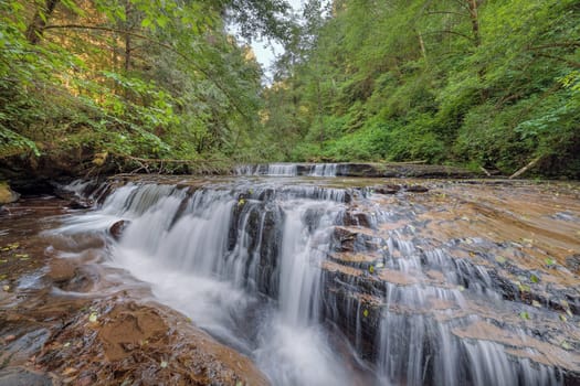 Tiered Cascading Waterfall Over Wide Ledge at Sweet Creek Falls Trail Complex in Mapleton Oregon