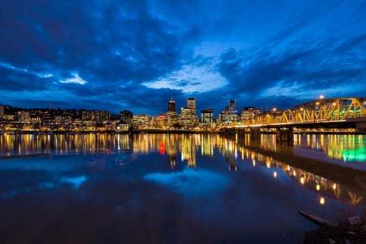 Hawthorne Bridge Over Willamette River to Portland Oregon Downtown City Skyline During Evening Blue Hour