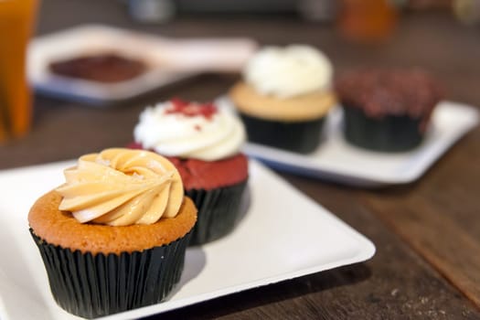 Cupcakes Variety Served on White Plates Closeup