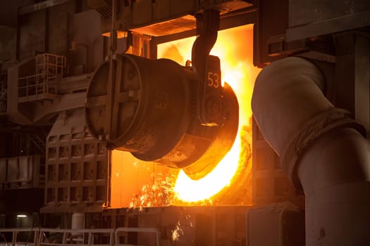 In the steelworks,the Bessemer converter is reloaded for steel production