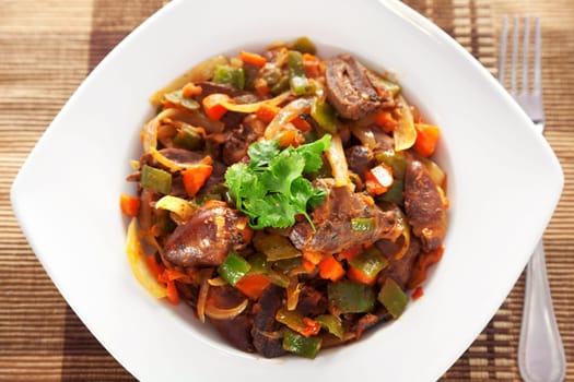 Duck hearts stew vegetables in a plate
