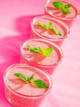 Raspberry cream with mint on pink background