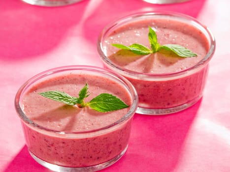Raspberry cream with mint on pink background