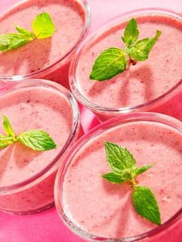 Raspberry cream with mint on pink background