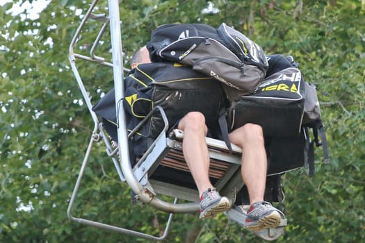 Have my armchair fully loaded - Supervisor with luggage of a ski jumper at the men's individual competition - FIS Sommer Grand Prix