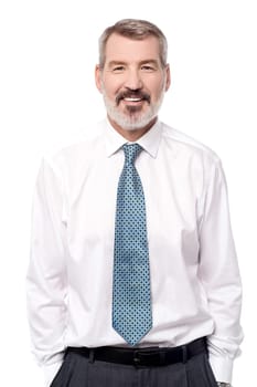 Smiling corporate male with hands in pockets