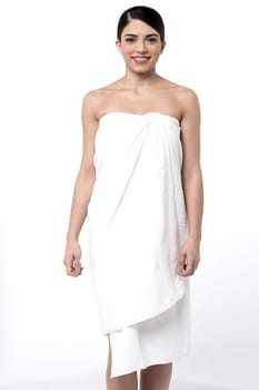 Pretty young woman covering herself with towel