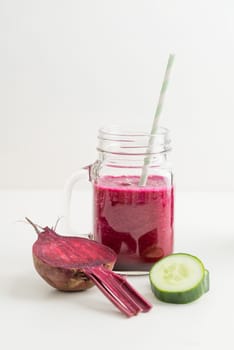 Red smoothie with beetroot and cucumber in a glass