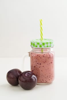 Pink healthy smoothie with yoghurt and plums