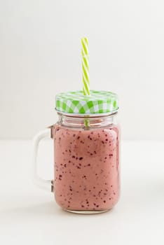 Pink healthy smoothie with yoghurt and plums