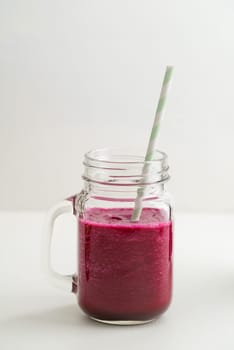 Red smoothie with beetroot and cucumber in a glass