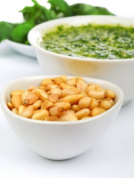 Pesto sauce with basil and pine nuts isolated on white