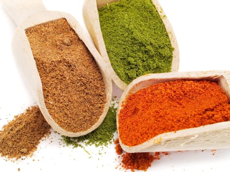 Red pepper, savory and black pepper on white