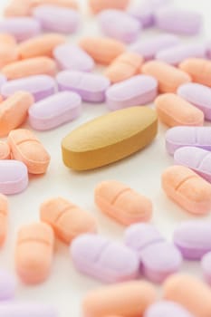 Pills spilling on a white background, Selective focus