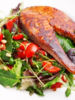 Baked marinated salmon with fresh salad of arugula and cherry tomatos