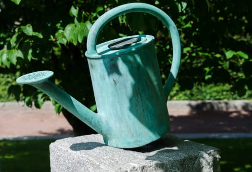 one old watering can on a stone beutiful decoration