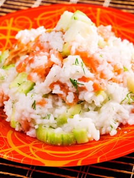 Rice with salmon and cucumbers salad