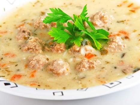 Portion of soup with meatballs in a plate