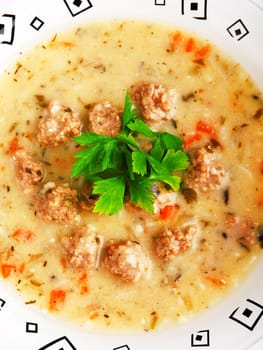 Portion of soup with meatballs in a plate