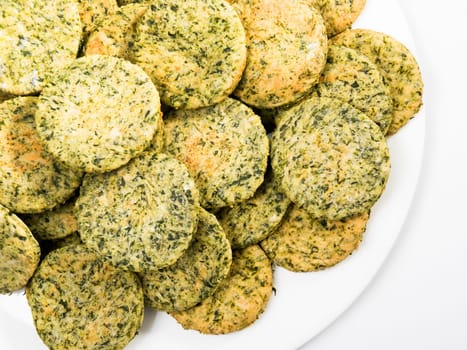Homemade biscuits with spinach in a basket, close up