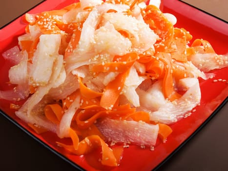 Healthy carrot and turnip salad with sesame, close up
