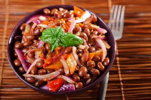 Bean salad with peppers and onion, served in a plate, ready-to-eat