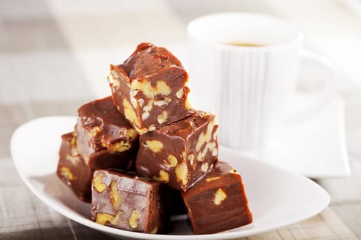 Homemade chocolate with walnuts and cup of coffee