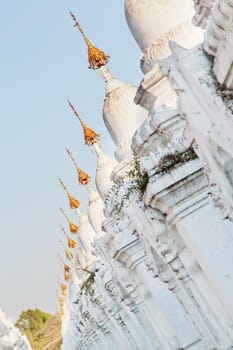 Kuthodaw Pagoda is a Buddhist stupa, located in Mandalay, Burma (Myanmar), that contains the world's largest book. It lies at the foot of Mandalay Hill. In the grounds of the pagoda are 729 stone-inscription caves, each containing a marble slab inscribed on both sides with a page of text from the Tipitaka, the entire Pali Canon of Theravada Buddhism. Pagoda Kuthodaw stretching from 1860 to 1868 during the reign of King Mindona.