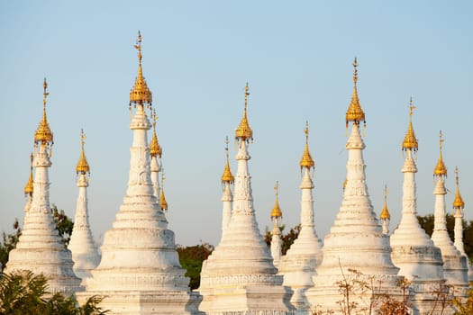 Kuthodaw Pagoda is a Buddhist stupa, located in Mandalay, Burma (Myanmar), that contains the world's largest book. It lies at the foot of Mandalay Hill. In the grounds of the pagoda are 729 stone-inscription caves, each containing a marble slab inscribed on both sides with a page of text from the Tipitaka, the entire Pali Canon of Theravada Buddhism. Pagoda Kuthodaw stretching from 1860 to 1868 during the reign of King Mindona.