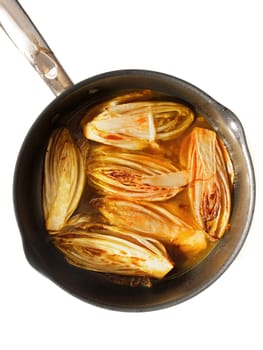 Side dish with fried chicory in sweet orange sauce, perfect for fish and white meat