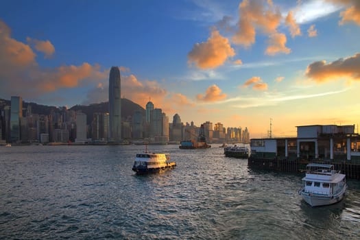 Hong Kong Island Central City Skyline from Kowloon Ferry Pier Along Victoria Harbor Sunset