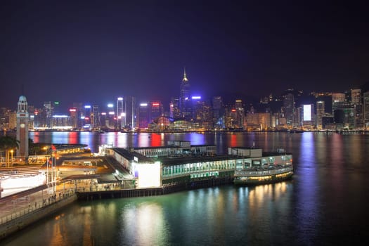 Kowloon Ferry Pier at Tsim Sha Tsui with Hong Kong Island Central City Skyline at Night