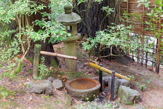 Tsukubai Water Fountain with Stone Basin and Bamboo Spigot and Stone Lantern at Portland Japanese Garden