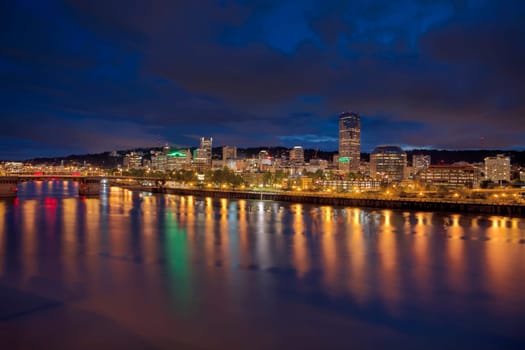 Portland Oregon Downtown City Skyline Along Willamette River Waterfront at Evening Blue Hour with Storm Clouds Panorama
