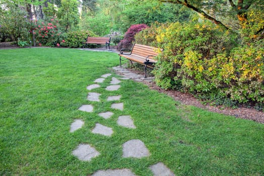 Natural Stone Steps on Green Grass Lawn to Park Bench