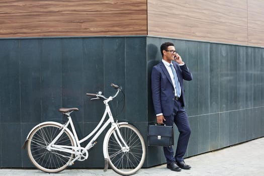 Modern agent speaking on the phone outdoors