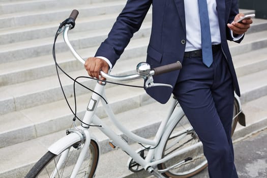 Businessman by bicycle using cellphone