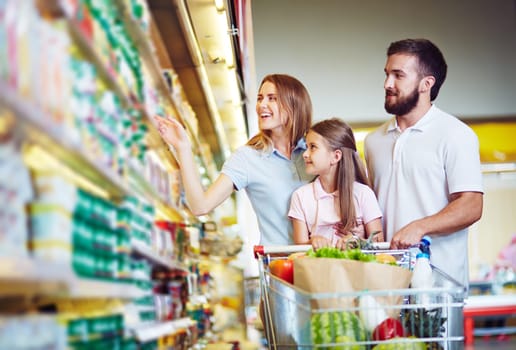 Young family choosing products